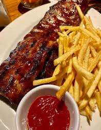 Grilled spare ribs with french fries and spicy tomato ketchup