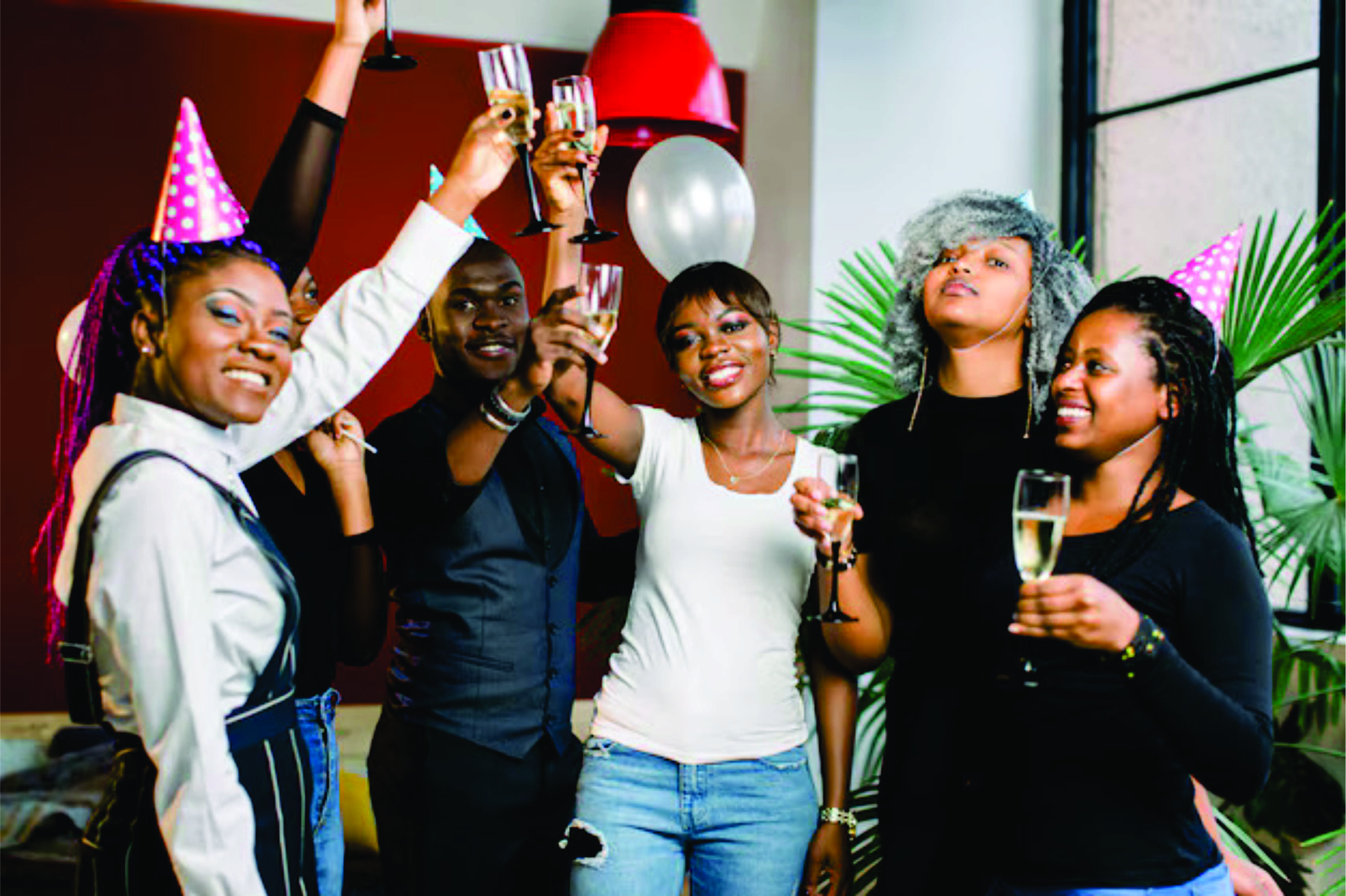 A group of young people raising their glasses at a party